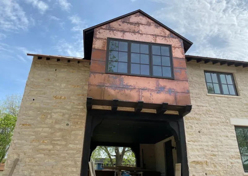 Copper metal panel facade on a stone building for Skylight Installation in Marianna