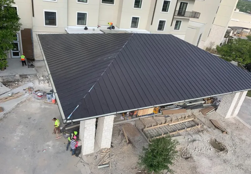 Metal roofing installation team working on a commercial building in Marianna